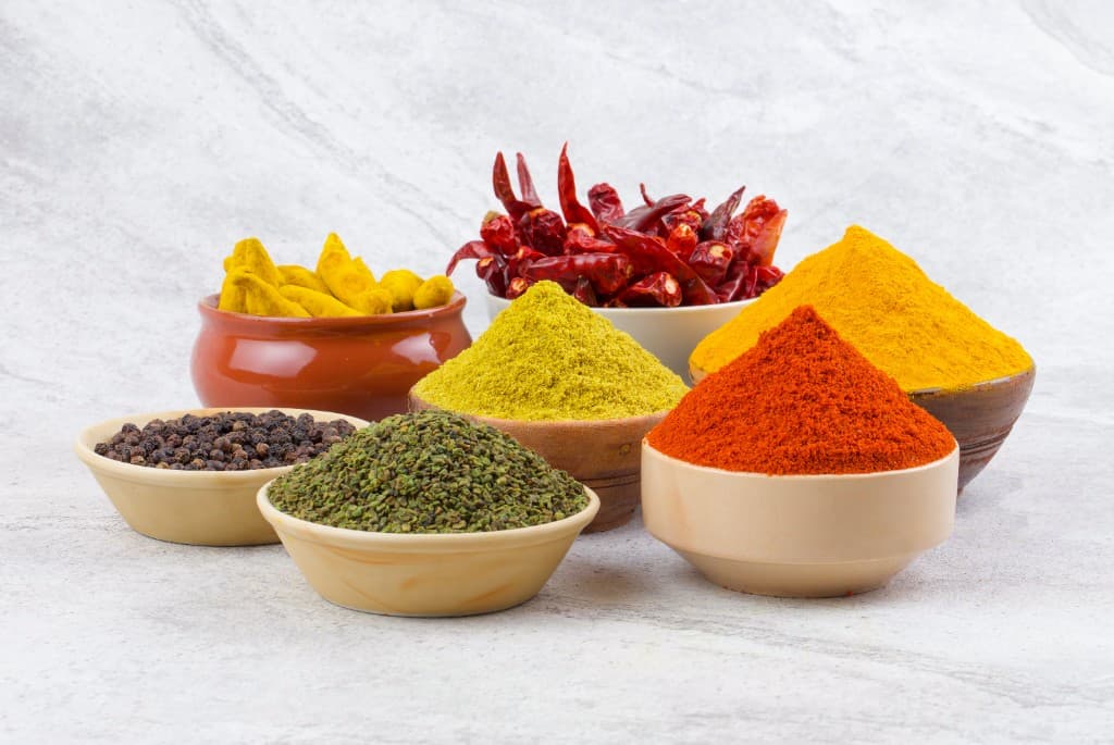 Collection of premium Indian spices in traditional bowls